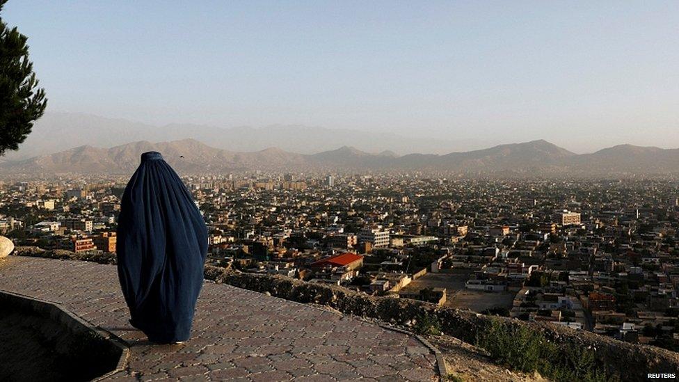 Afghan woman on a hilltop overlooking Kabul