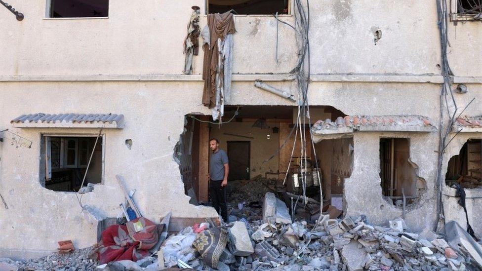 A Palestinian checks his house that was damaged during Israel-Gaza fighting, as ceasefire holds, in Gaza City August 8, 2022.