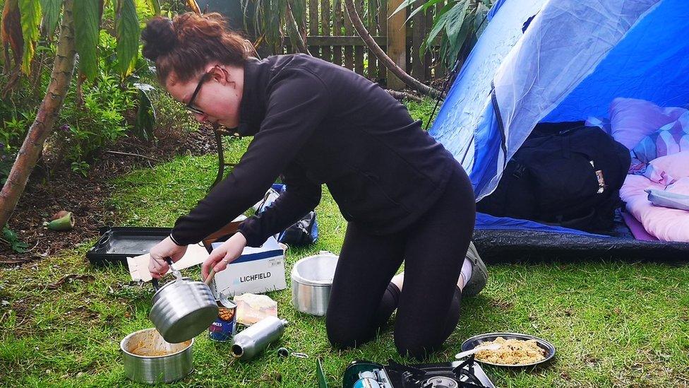 Izzy Fellows-Barnett with camp cooking equipment