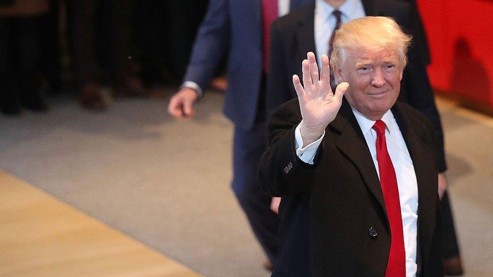 President-elect Donald Trump walks through the lobby of the New York Times following a meeting with editors at the paper on in New York City.