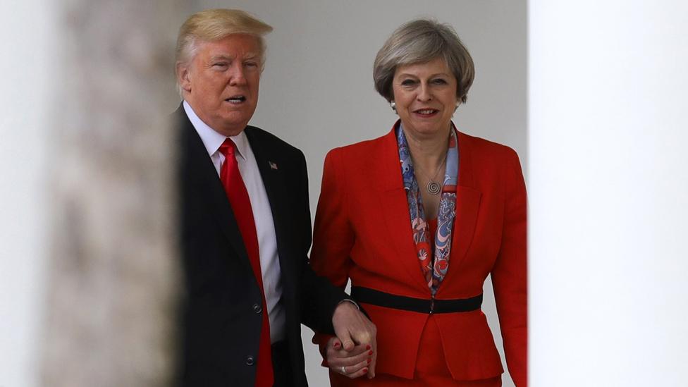 Donald Trump holds Theresa May's hand at the White House