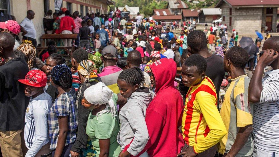 Voters wait in line to cast their ballot outside the Kibancha polling station in Sake, North Kivu, on December 30, 2018