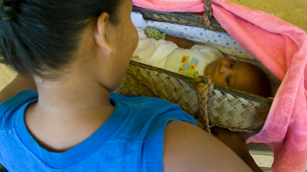 A file photo of a mother looking at her baby