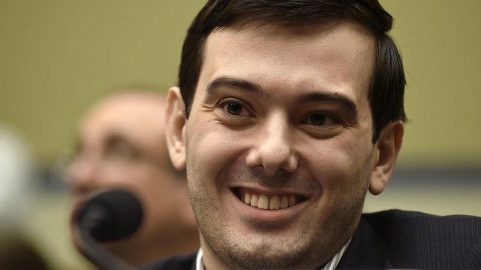 Pharmaceutical chief Martin Shkreli smiles on Capitol Hill in Washington.