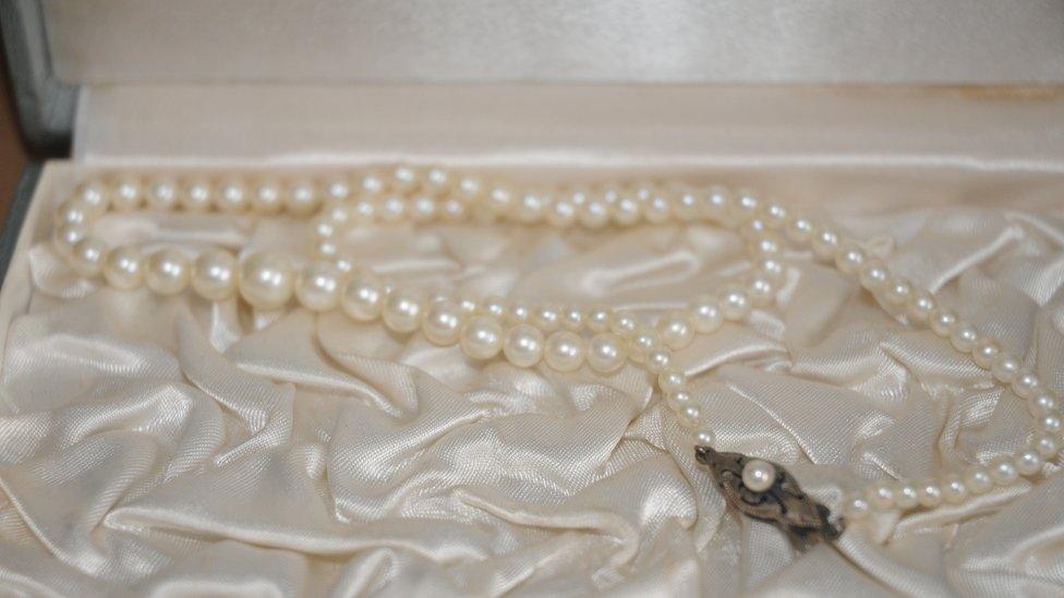 A pearl necklace in a case