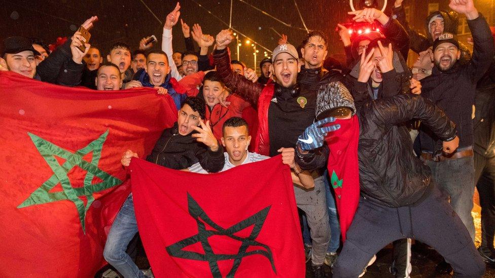 a large group of men with flags