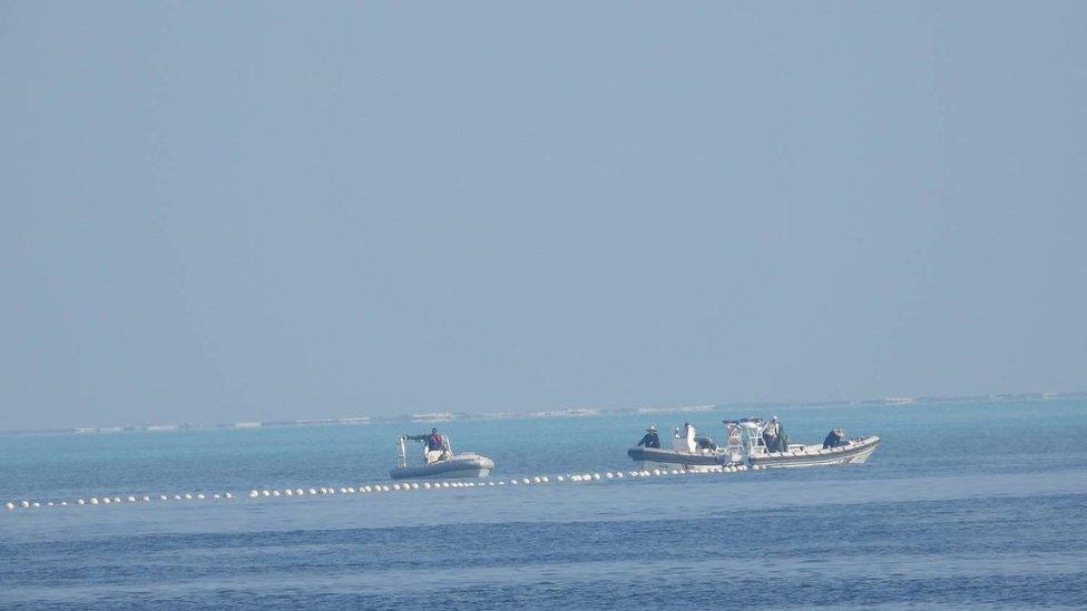 Chinese Coast Guard boats close to the floating barrier are pictured near the Scarborough Shoal