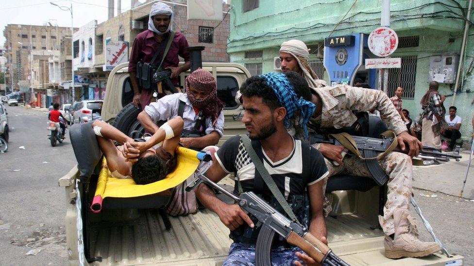 Yemeni pro-government fighters rush a comrade to the hospital on the back of a pick-u[ truck after he was injured in clashes with Houthi fighters in Taiz (25 May 2017)