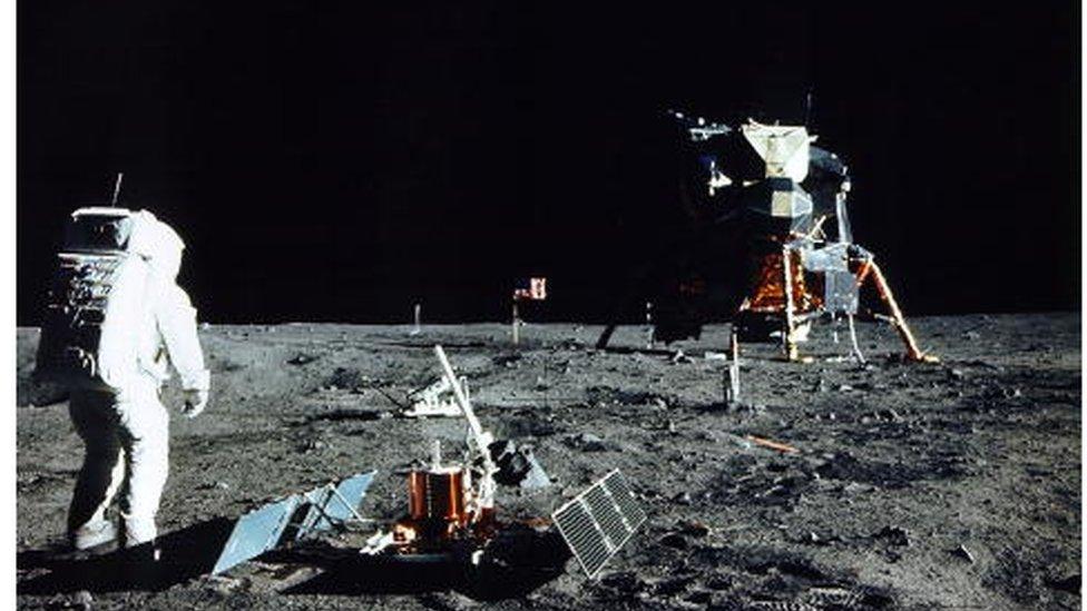 Astronaut Edwin E. Aldrin Jr., Lunar Module Pilot, stands near a scientific experiment on the lunar surface. Man's first landing on the Moon occurred July 20, 1969 as Lunar Module "Eagle" touched down gently on the Sea of Tranquility on the east side of the Moon.