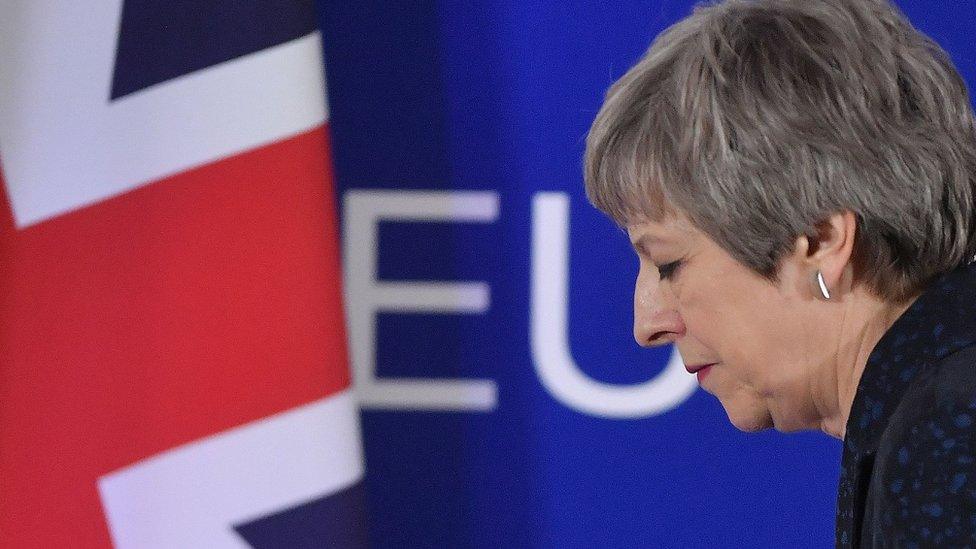 British Prime Minister Theresa May walks away after holding a press conference in Brussels on March 22, 2019