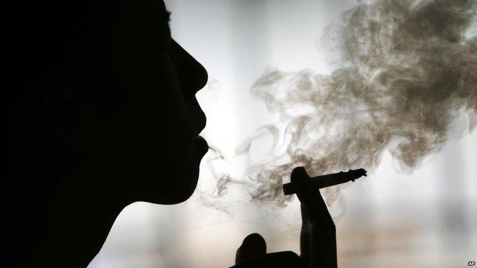 A Chinese man smokes a cigarette