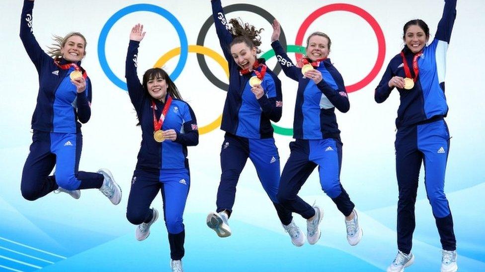 women's curling team celebrate winning gold