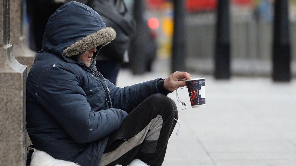 Homeless person begging on the street