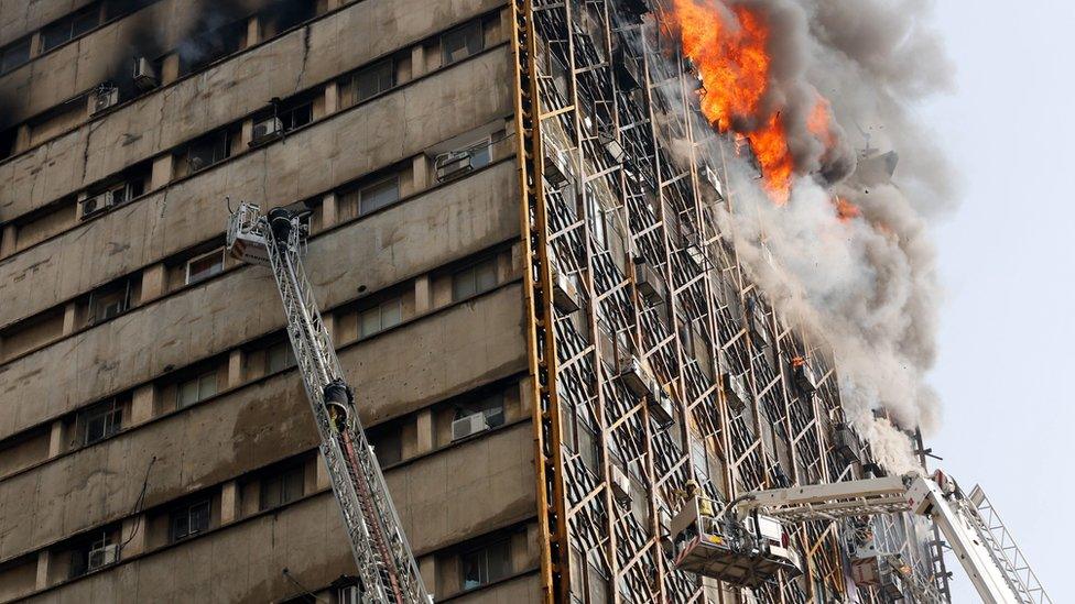 Smoke pours from the Plasco building in Tehran, Iran, shortly before it collapses (19 January 2017)