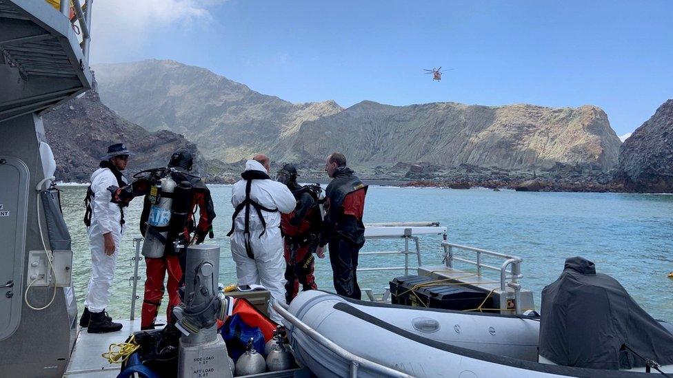 Members of a dive squad conduct a search during a recovery operation around White Island