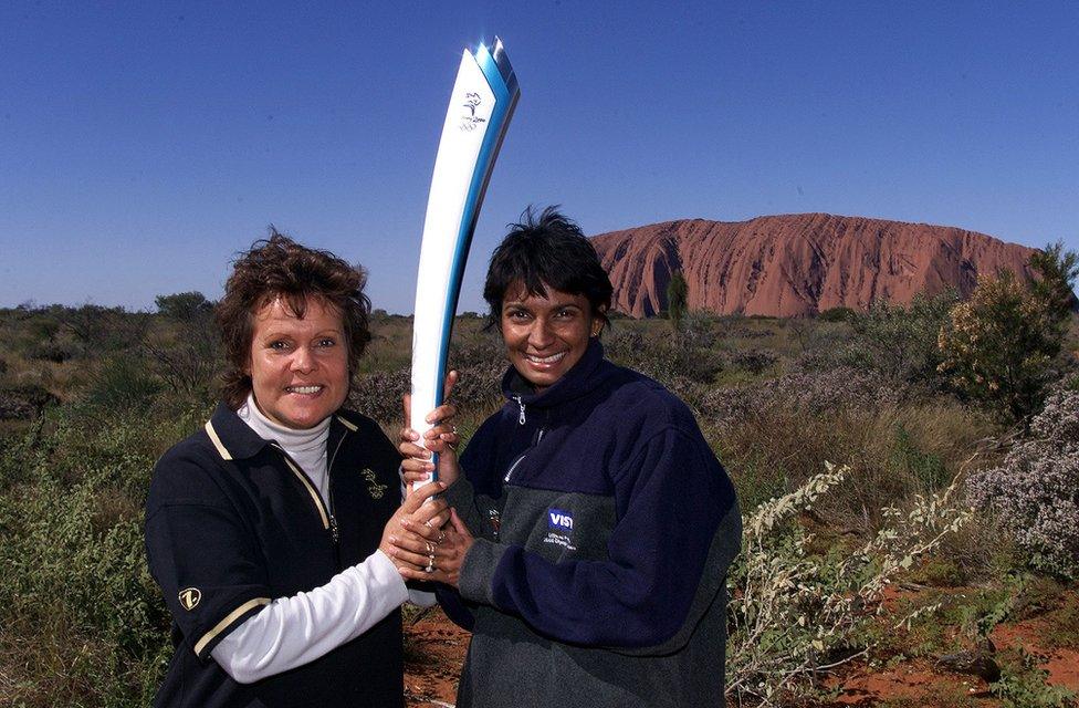 Nova Peris-Kneebone and Evonne (Goolagong) Cawley hold the Olympic torch in 2000