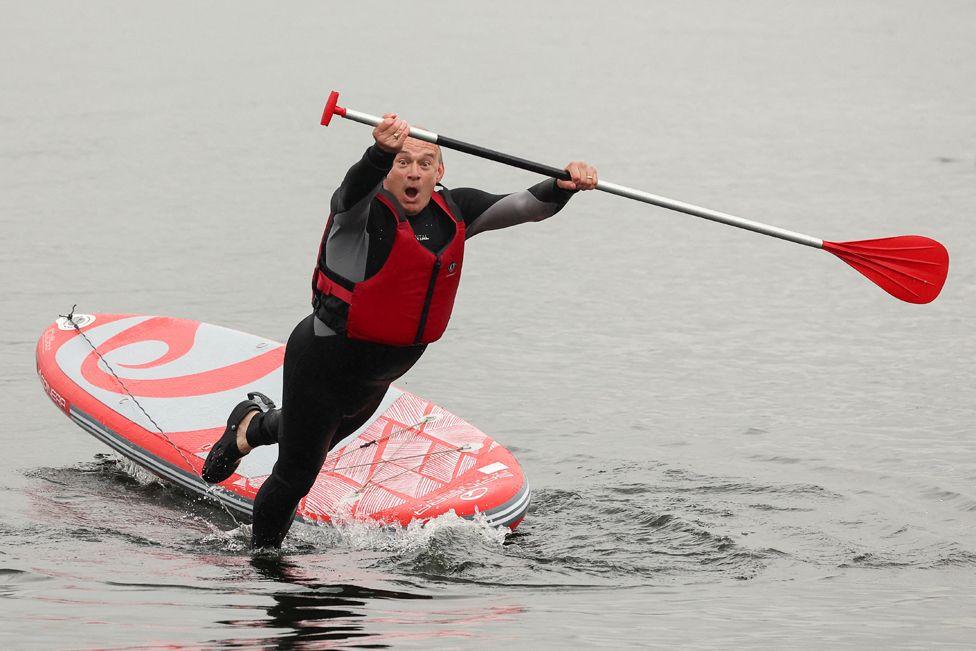 British leader of the Liberal Democrats party Ed Davey falls from a paddle board, at Lake Windermere in Windermere, Britain, 28 May 2024