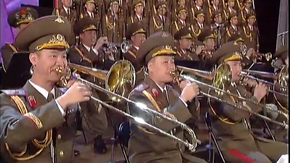 The State Merited Chorus and band on North Korean Central TV