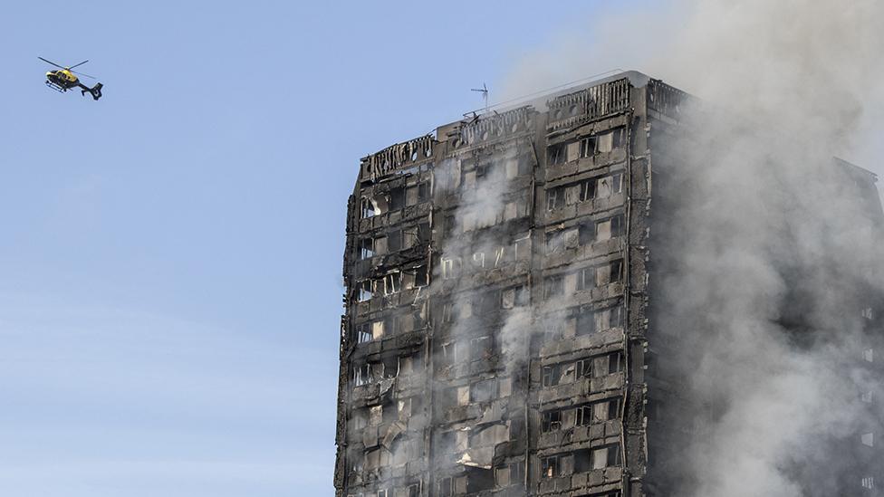 Grenfell Tower, smouldering on the day after the fire