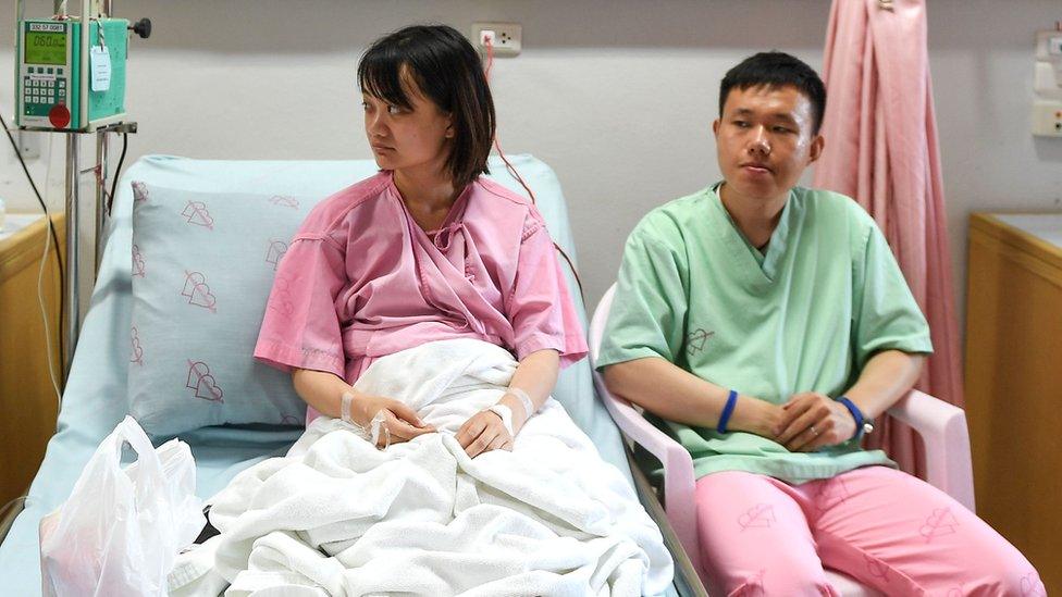 Rescued passengers of the capsized tourist boat in rough seas Wu Jun 28 (R) and his wife Long Haining 29 (L) in Phuket, 6 July 2018