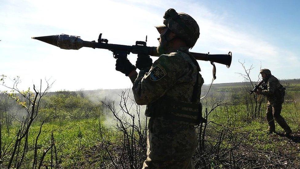 A member of the Ukrainian military prepares to fire a rocket-propelled grenade (RPG) near the city of Bakhmut