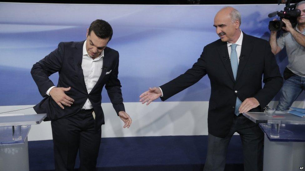 Microphone cable prevents Alexis Tsipras from shaking hands with his rival