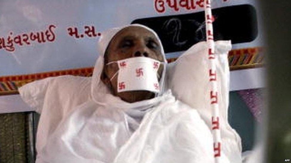 Indian woman Taraben Chovatia, 78, rests as she undergoes the Jain practice of Santhara or voluntary death by fasting at an upashray (Jain monastery) in Mumbai, on April 6, 2008. Chovatia has renounced food for the last 14 days as she sits in the company of Sadhvis or nuns, as her only source of nourishment is two glasses of water during the d