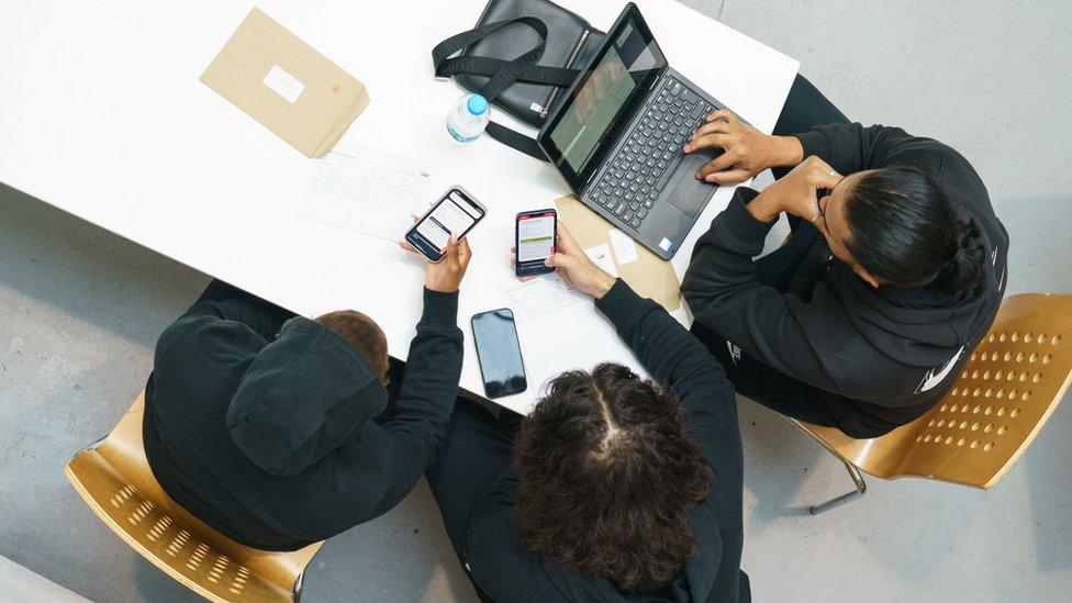 Students gather round laptop and phones for A-level results