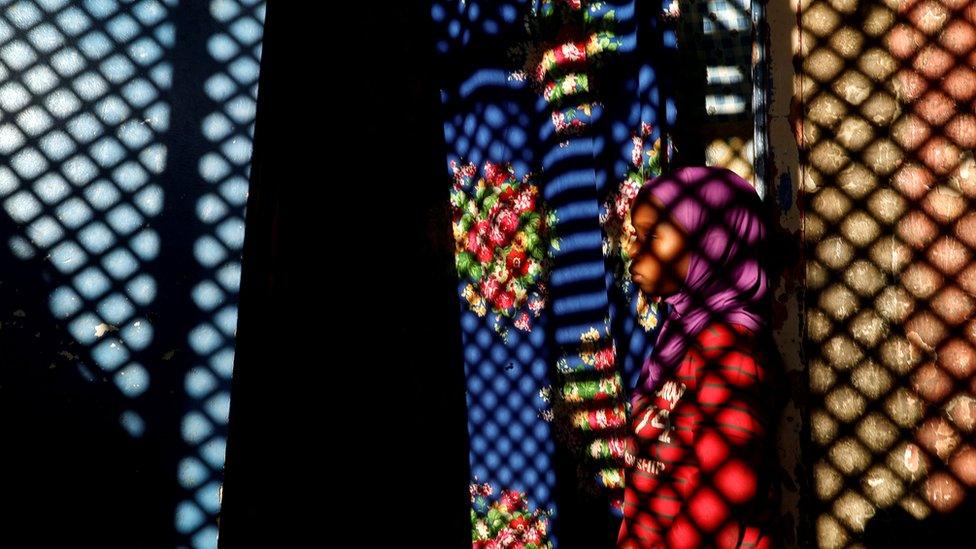 A girl stands outside her one-room home in Medina neighbourhood, Dakar, Senegal - 11 December 2018