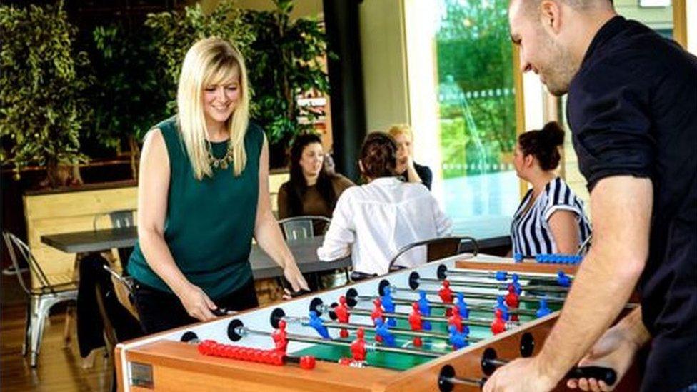 People playing table football at Moneypenny office