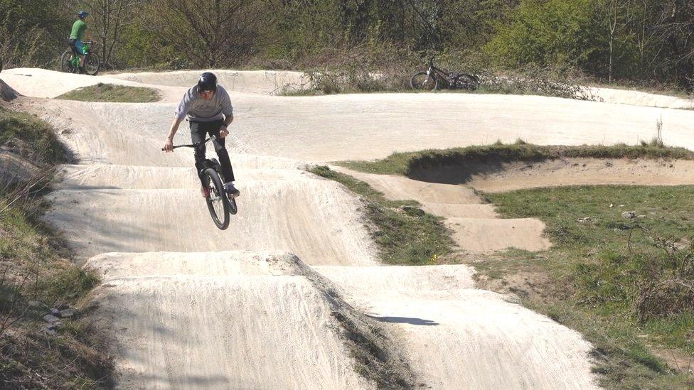 A man rides a jump on the track