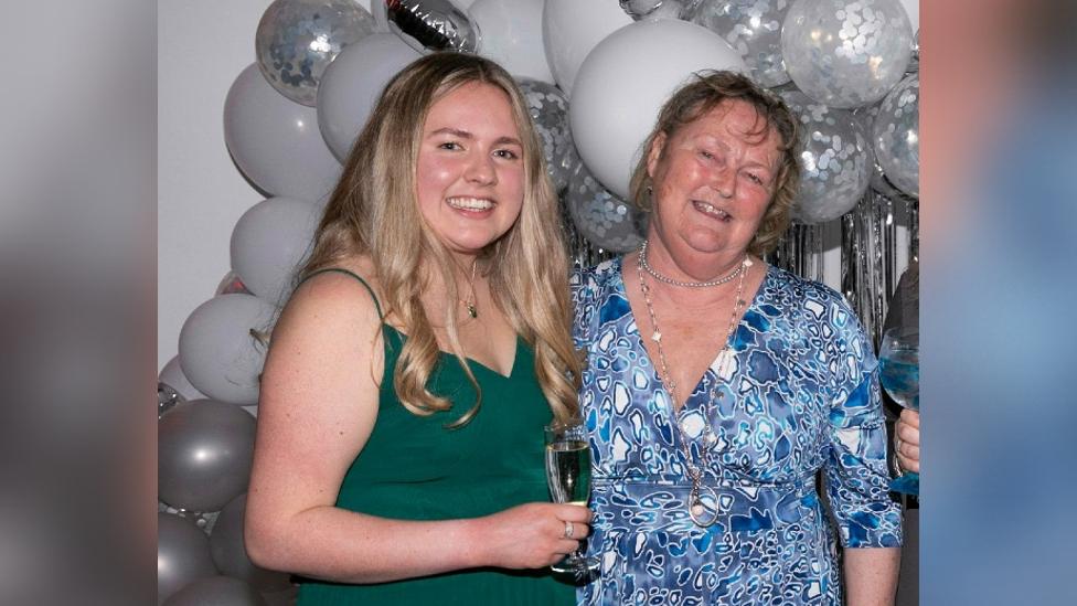 Megan and Lynne stood next to each other behind a big baloon display