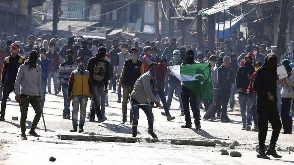 Kashmiri Muslim protestors throw stones at Indian police and paramilitary soldiers during clashes in the downtown area of Srinagar,