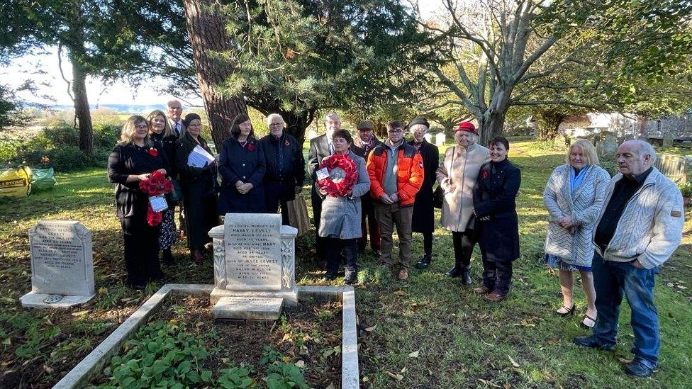 A wreath was laid at his family's gravestone, in the adjacent church