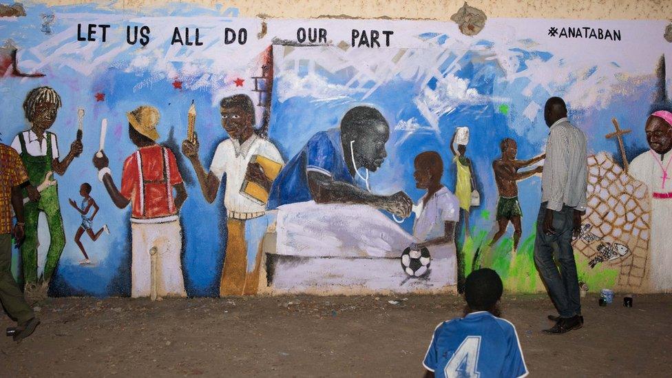 A closeup of the same mural, with a student holding a notebook and pencil, a priest and a woman with a bucket on her head. Also the Dr as described above.