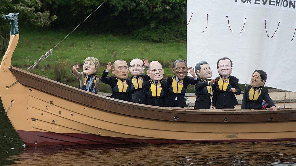 Demonstrators from the 'IF campaign' wearing masks depicting G8 leaders protest against tax avoidance during the G8 Summit in Enniskillen, in Northern Ireland, on June 17, 2013.