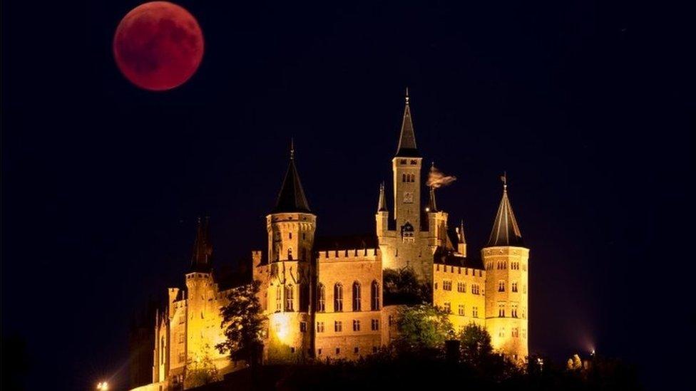 A Blood Moon rises behind The Hohenzollern Castle, the ancestral seat of the Prussian Royal House and of the Hohenzollern Princes, situated at the periphery of the Swabian Alb on July 27, 2018 in Hechingen, Germany.