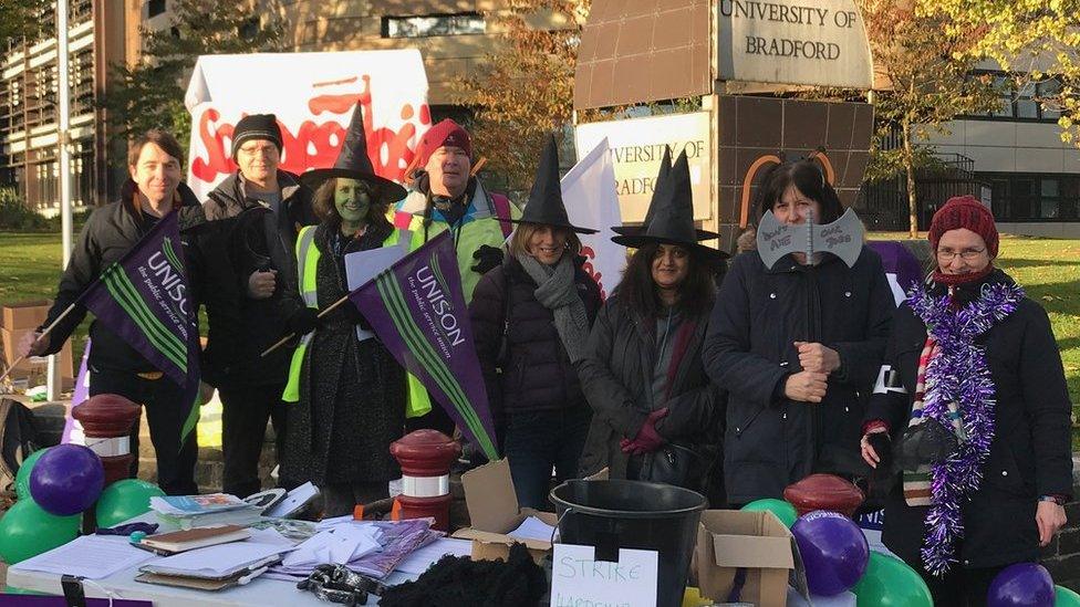 People dressed in Halloween costumes on a picket line