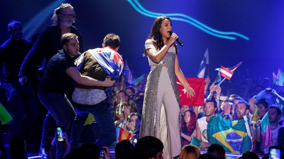 Stewards tackle a stage invader during Jamala's Eurovision Song Contest perfomrance