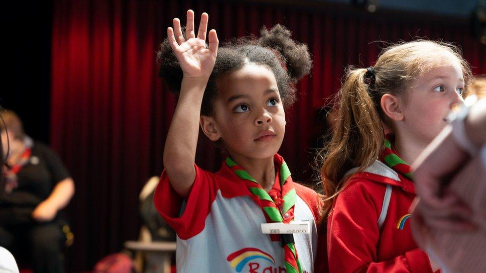 Rainbow raising her hand at a digital session