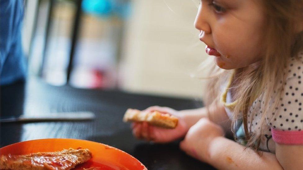 A child eats peanut butter