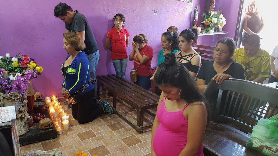 A group of people prays to Santa Muerte in Guadalajara