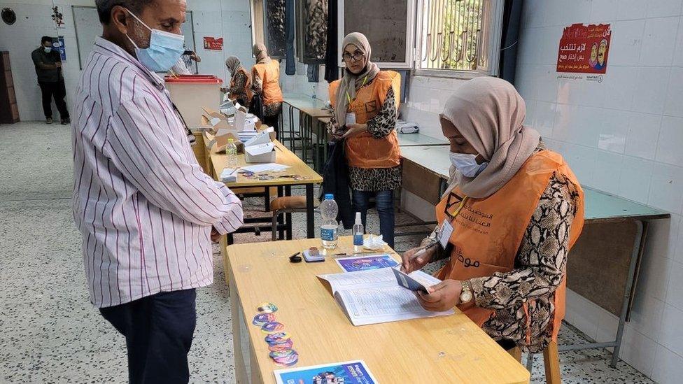 A Libyan man registers to vote inside a polling station in Tripoli, on November 8, 2021