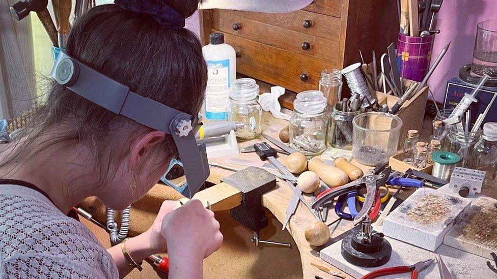 Ruth working on a piece of jewellery at her bench