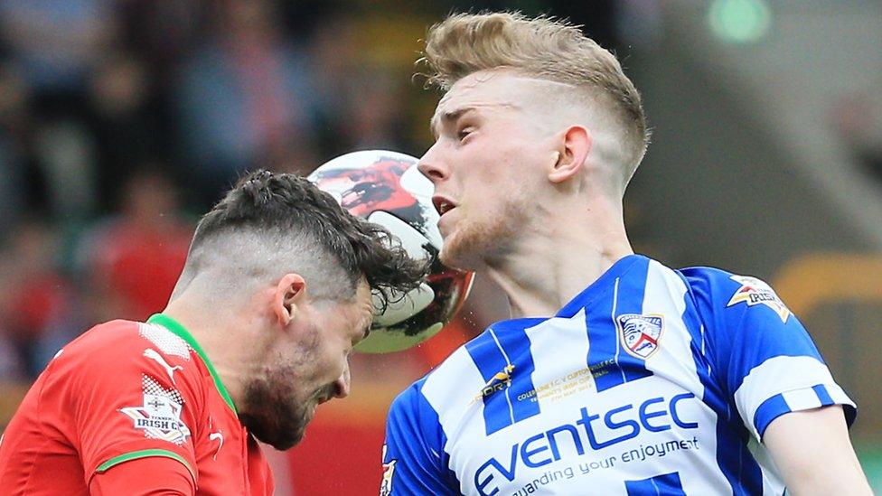 Cliftonville's Tomas Cosgrove competes with Jamie McGonigle of Coleraine during the first ever Irish Cup final between the clubs