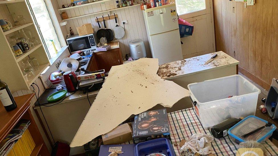 A chunk of ceiling that has fallen onto the kitchen