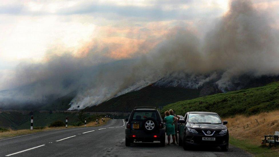 Motorists watch the wildfire above Horseshoe Pass in North Wales