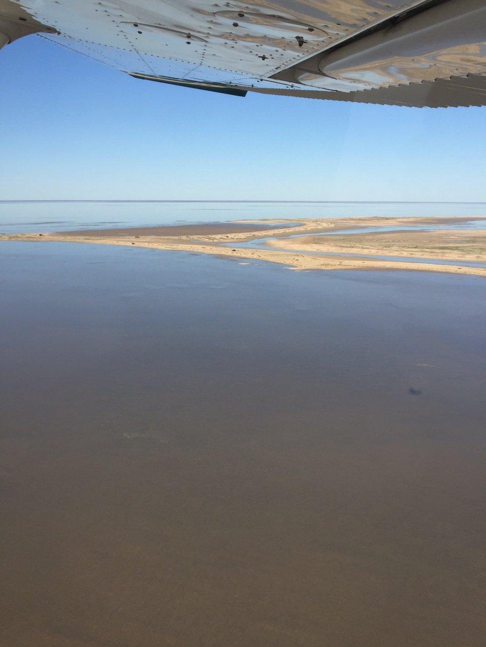 Sand banks peak above the water in Lake Eyre