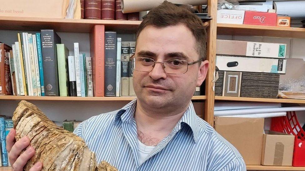 Dr Simon Jackson with a mammoth tooth