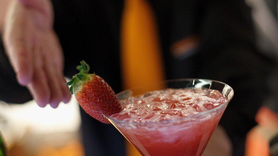 A bartender serves an Apache cocktail